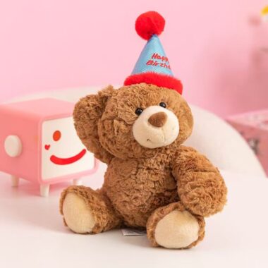 Cute teddy bear plush wearing a colorful birthday hat
