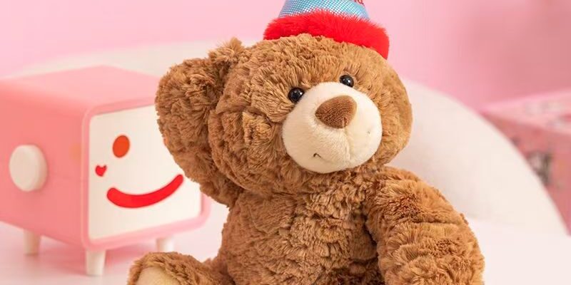 Cute teddy bear plush wearing a colorful birthday hat