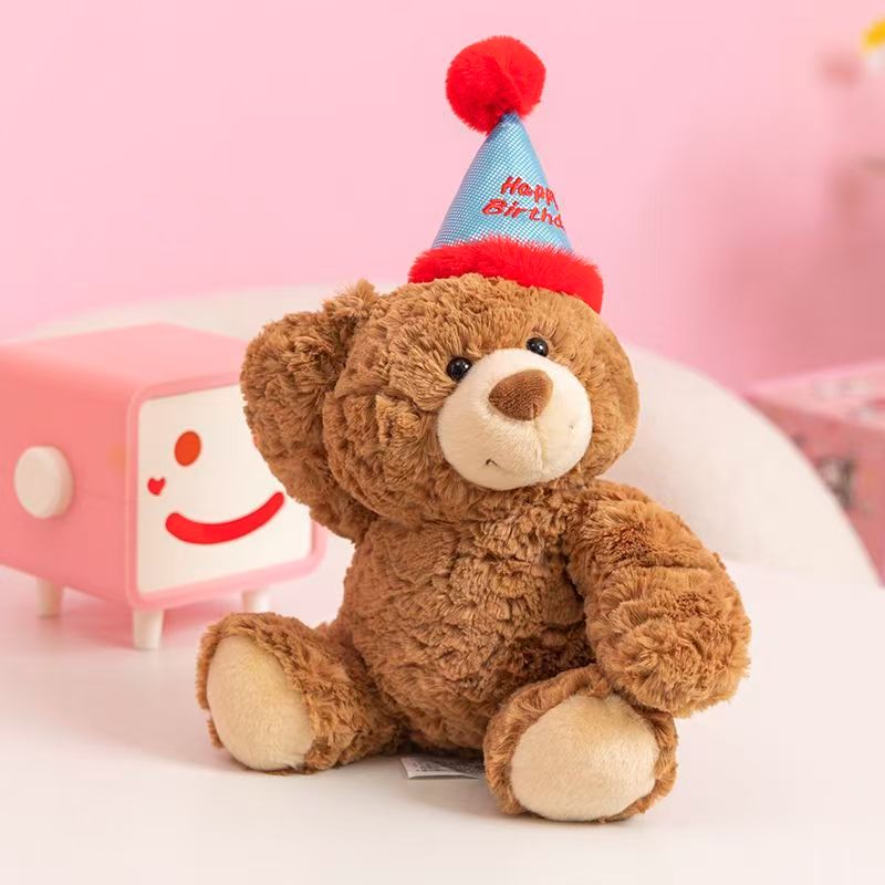 Cute teddy bear plush wearing a colorful birthday hat