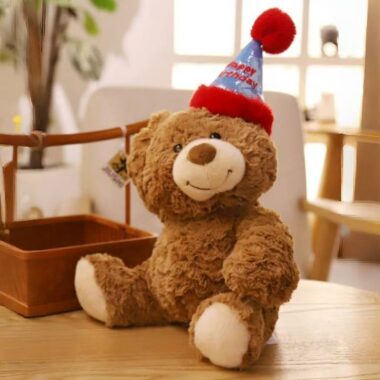 Cute teddy bear plush wearing a colorful birthday hat