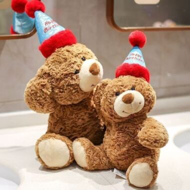 Cute teddy bear plush wearing a colorful birthday hat