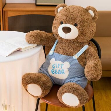 Cute teddy bear in strap overalls for birthday gifting