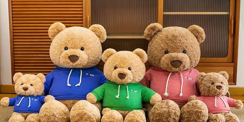 Cute teddy bear plush wearing a soft hoodie outfit