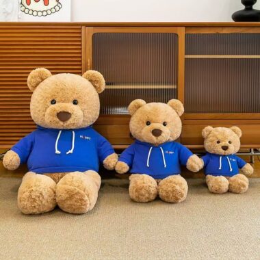 Cute teddy bear plush wearing a soft hoodie outfit
