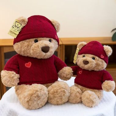 Cute teddy bear plush wearing a knitted sweater outfit