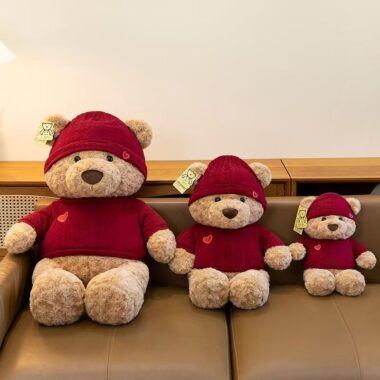 Cute teddy bear plush wearing a knitted sweater outfit