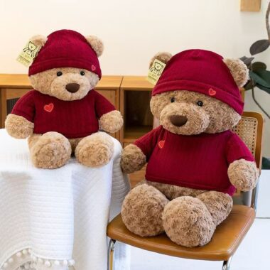 Cute teddy bear plush wearing a knitted sweater outfit