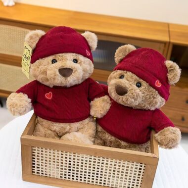 Cute teddy bear plush wearing a knitted sweater outfit