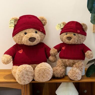 Cute teddy bear plush wearing a knitted sweater outfit