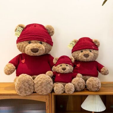 Cute teddy bear plush wearing a knitted sweater outfit