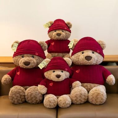 Cute teddy bear plush wearing a knitted sweater outfit