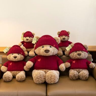 Cute teddy bear plush wearing a knitted sweater outfit