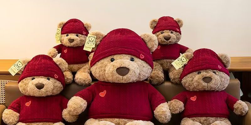 Cute teddy bear plush wearing a knitted sweater outfit