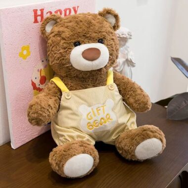 Soft teddy bear plush wearing adorable overalls outfit