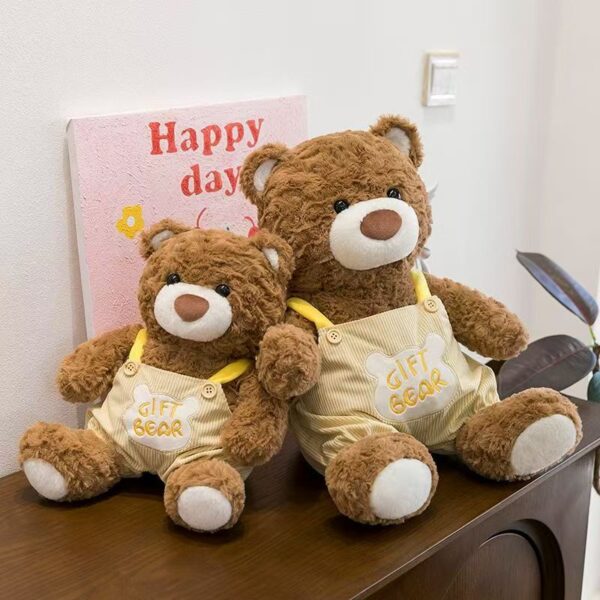 Soft teddy bear plush wearing adorable overalls outfit