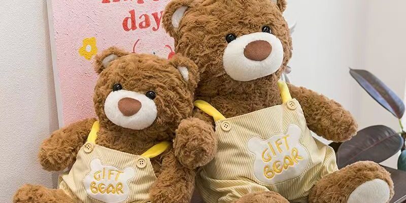 Soft teddy bear plush wearing adorable overalls outfit
