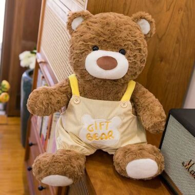 Soft teddy bear plush wearing adorable overalls outfit
