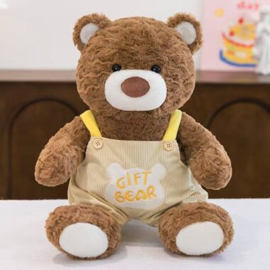 Soft teddy bear plush wearing adorable overalls outfit