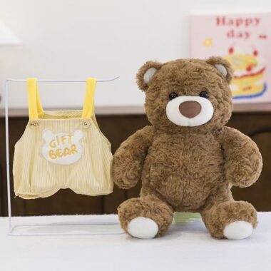 Soft teddy bear plush wearing adorable overalls outfit