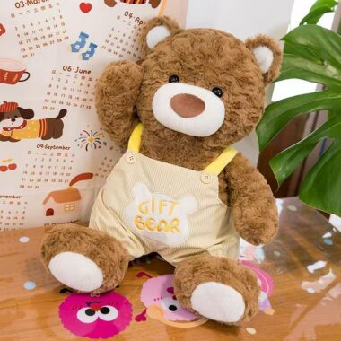 Soft teddy bear plush wearing adorable overalls outfit