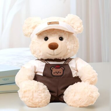 Soft cute teddy bear plush wearing strap-style outfit