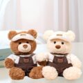 Soft cute teddy bear plush wearing strap-style outfit