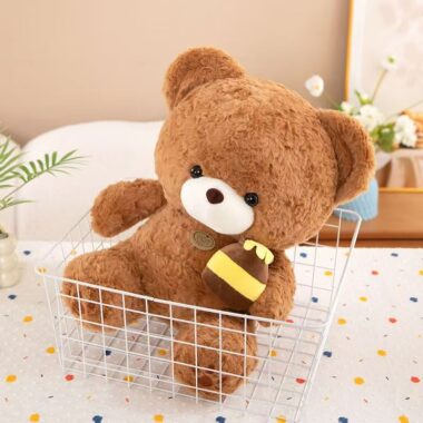 Soft cute teddy bear plush holding a honey pot for gifting