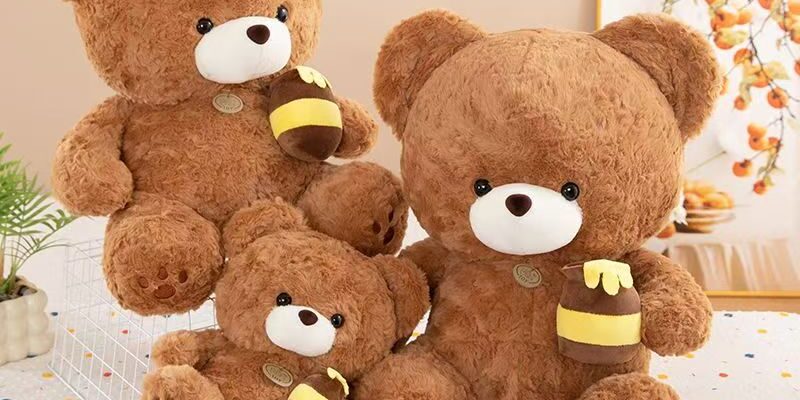 Soft cute teddy bear plush holding a honey pot for gifting